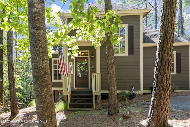 exterior space featuring roof with shingles