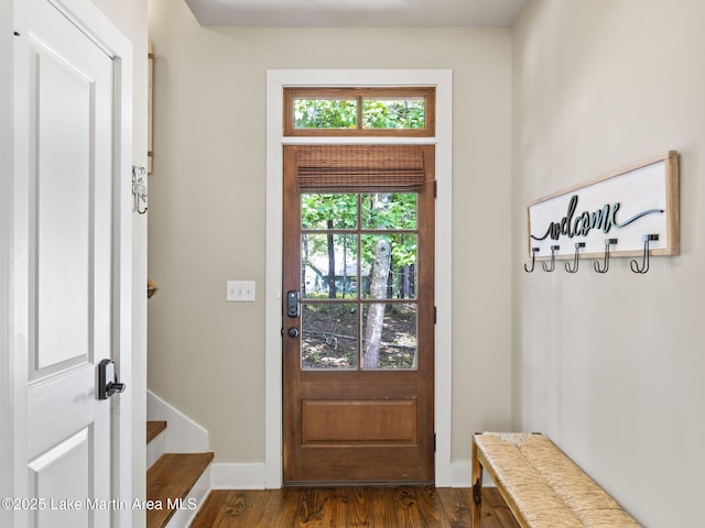 doorway to outside featuring dark wood-type flooring and baseboards