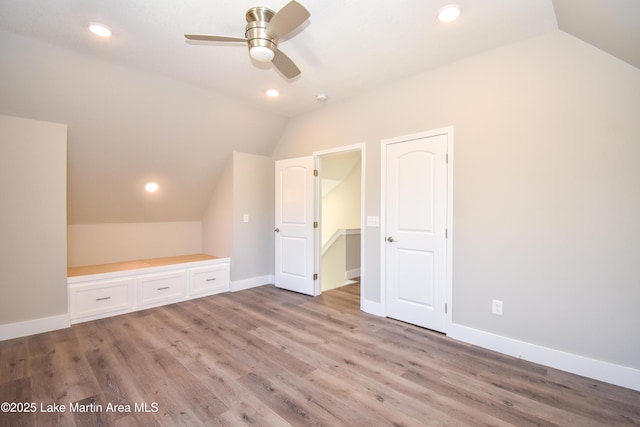 additional living space with light wood-type flooring, ceiling fan, and lofted ceiling