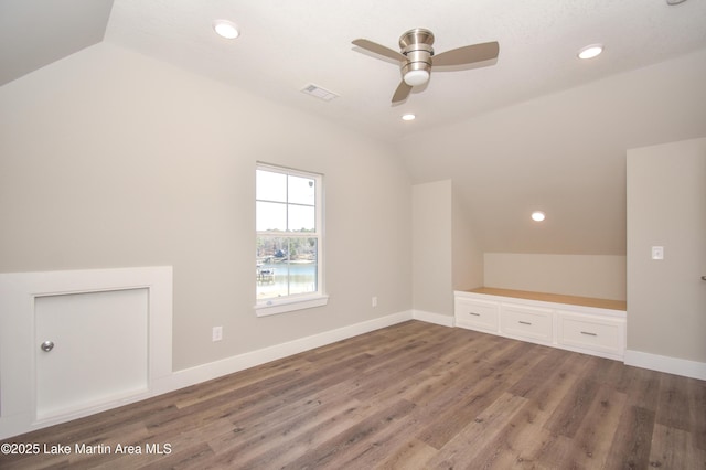 bonus room with ceiling fan, wood-type flooring, and vaulted ceiling