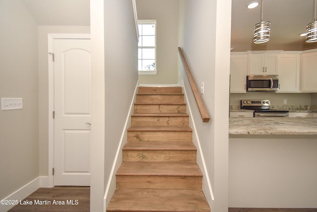 stairs with hardwood / wood-style flooring