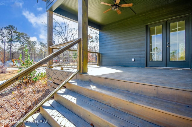 wooden deck with ceiling fan and french doors