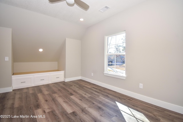 bonus room with dark hardwood / wood-style flooring, ceiling fan, and lofted ceiling