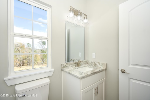 bathroom with vanity and toilet