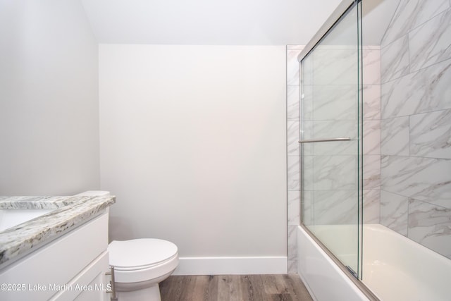 full bathroom with shower / bath combination with glass door, vanity, wood-type flooring, and toilet