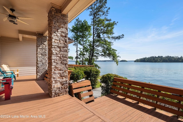 wooden deck featuring ceiling fan and a water view