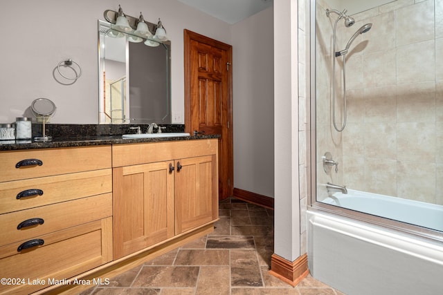 bathroom featuring vanity and enclosed tub / shower combo