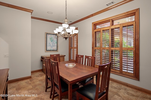 dining room with crown molding and a notable chandelier