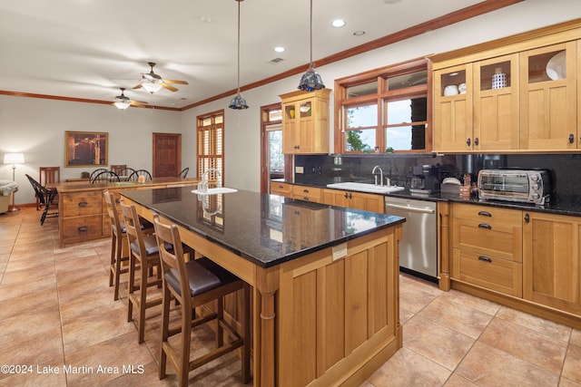 kitchen with tasteful backsplash, ceiling fan, pendant lighting, dishwasher, and a kitchen island