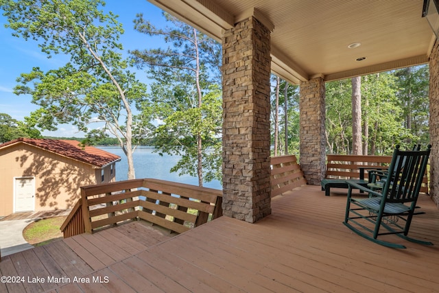 wooden terrace featuring a water view