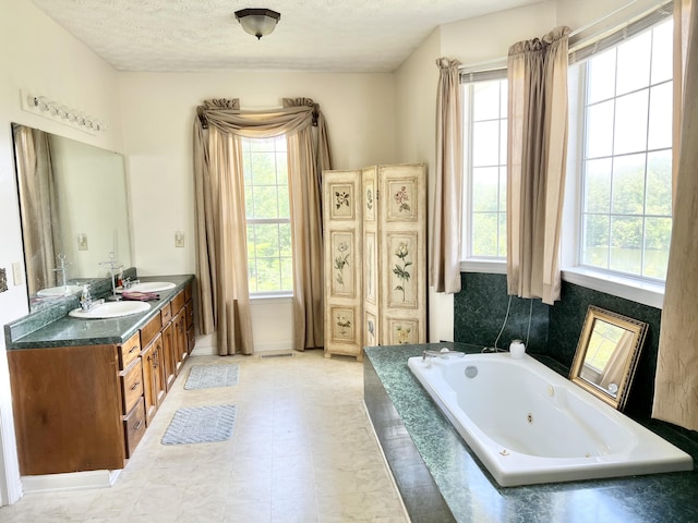 1370 County Road 759, Clanton, AL 35045 - full bathroom featuring plenty of natural light, double vanity, a tub with jets, and a textured ceiling