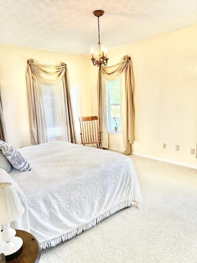 1370 County Road 759, Clanton, AL 35045 - bedroom with a chandelier, carpet floors, and a textured ceiling