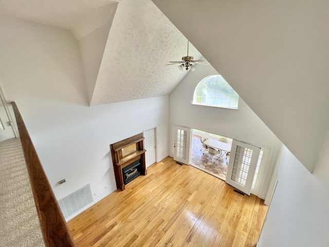 1370 County Road 759, Clanton, AL 35045 - unfurnished living room with high vaulted ceiling, wood-type flooring, a fireplace, and ceiling fan