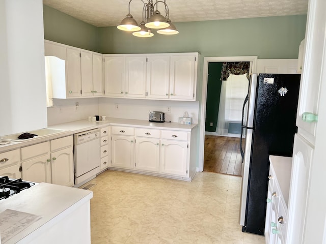 1370 County Road 759, Clanton, AL 35045 - kitchen with white dishwasher, freestanding refrigerator, white cabinets, decorative light fixtures, and light countertops