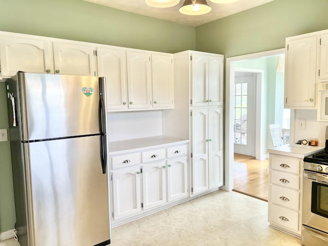 1370 County Road 759, Clanton, AL 35045 - kitchen with stainless steel appliances, white cabinetry, and light countertops