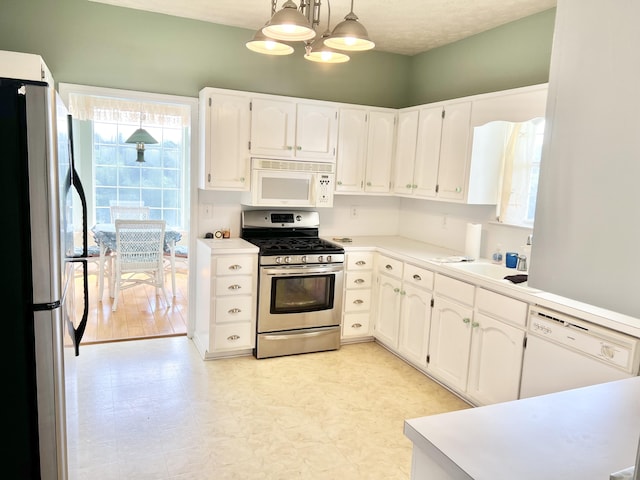 1370 County Road 759, Clanton, AL 35045 - kitchen featuring stainless steel appliances, white cabinetry, light floors, light countertops, and pendant lighting