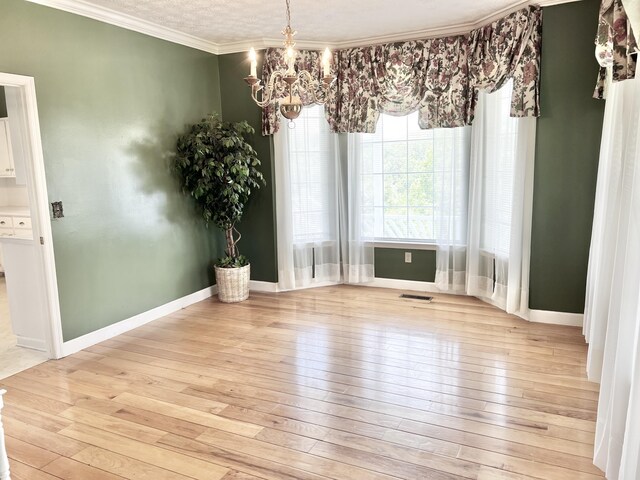 1370 County Road 759, Clanton, AL 35045 - unfurnished dining area featuring light wood-style flooring, a chandelier, and crown molding