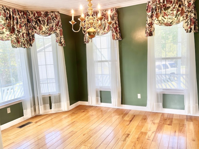 1370 County Road 759, Clanton, AL 35045 - unfurnished dining area featuring a chandelier, ornamental molding, hardwood / wood-style flooring, and plenty of natural light