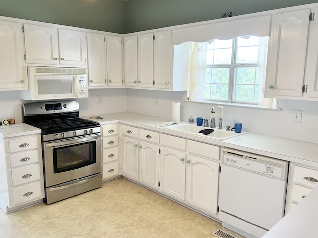 1370 County Road 759, Clanton, AL 35045 - kitchen with white appliances, white cabinetry, light countertops, and light flooring