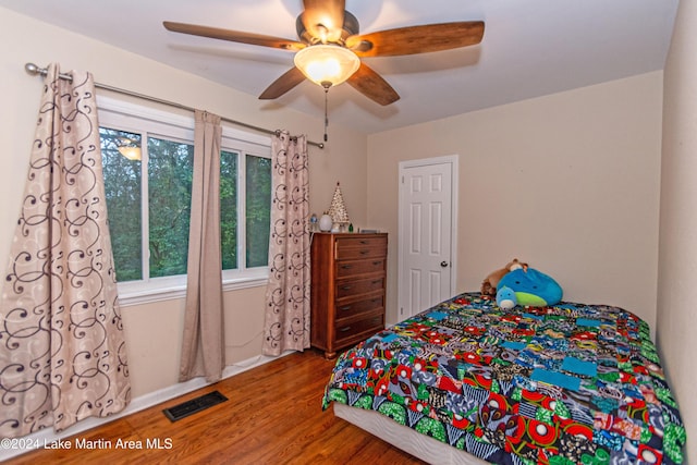 bedroom with ceiling fan and hardwood / wood-style floors