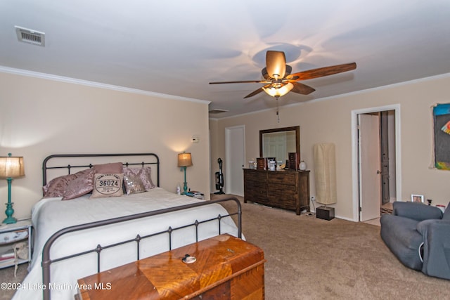 carpeted bedroom featuring ceiling fan and crown molding