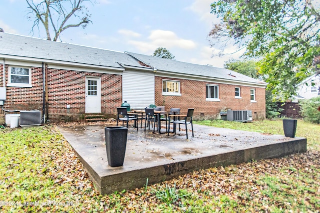 rear view of house featuring cooling unit and a patio