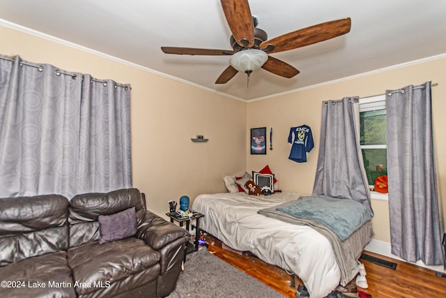 bedroom featuring wood-type flooring, ceiling fan, and crown molding