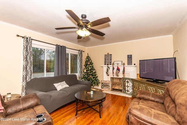 living room with crown molding, ceiling fan, and hardwood / wood-style flooring