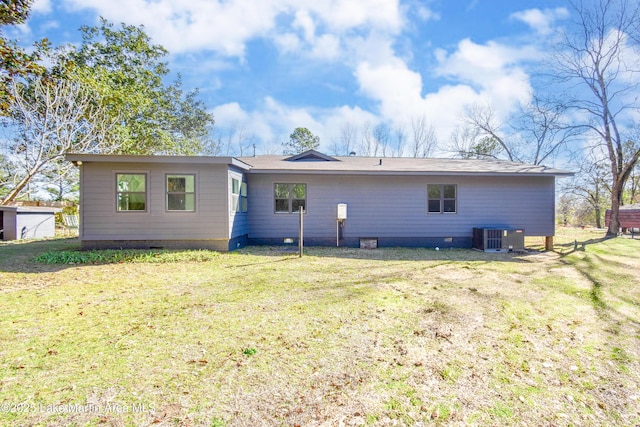 back of property with cooling unit and a yard