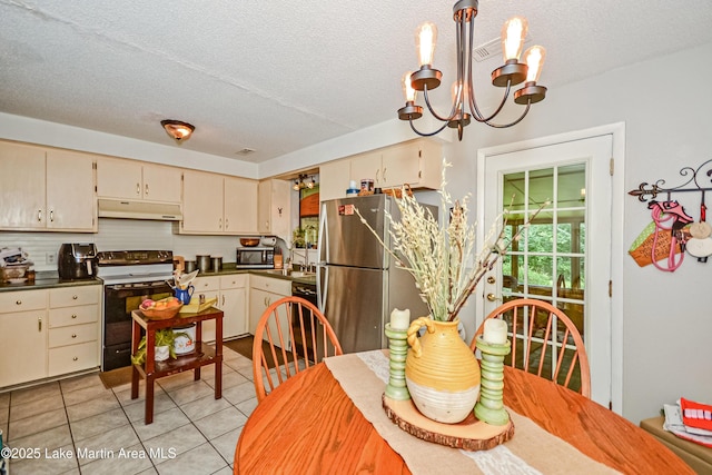 3464 Dobbs Rd, Alexander City, AL 35010 - dining area featuring a chandelier, light tile patterned floors, and a textured ceiling