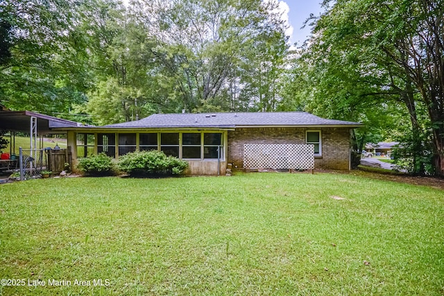 3464 Dobbs Rd, Alexander City, AL 35010 - back of property featuring a lawn, a sunroom, and brick siding