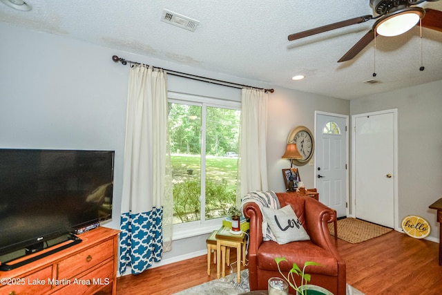 3464 Dobbs Rd, Alexander City, AL 35010 - living room featuring wood finished floors, ceiling fan, and a textured ceiling