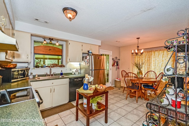 3464 Dobbs Rd, Alexander City, AL 35010 - kitchen featuring stainless steel appliances, a chandelier, light tile patterned flooring, a textured ceiling, and decorative light fixtures