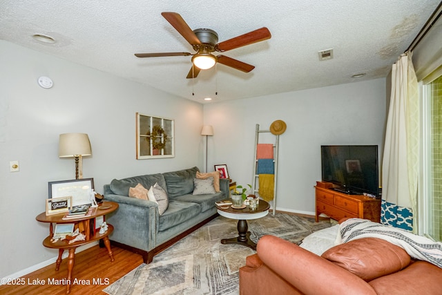 3464 Dobbs Rd, Alexander City, AL 35010 - living area with ceiling fan, a textured ceiling, and wood finished floors