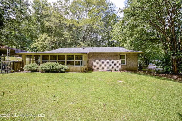 3464 Dobbs Rd, Alexander City, AL 35010 - rear view of property with brick siding and a sunroom