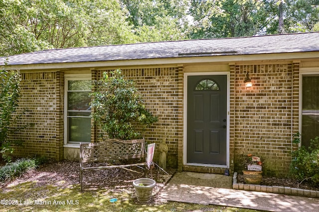 3464 Dobbs Rd, Alexander City, AL 35010 - view of exterior entry featuring brick siding and roof with shingles