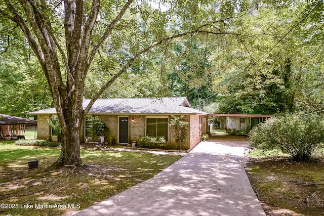 3464 Dobbs Rd, Alexander City, AL 35010 - ranch-style house featuring concrete driveway, a carport, brick siding, and a front lawn