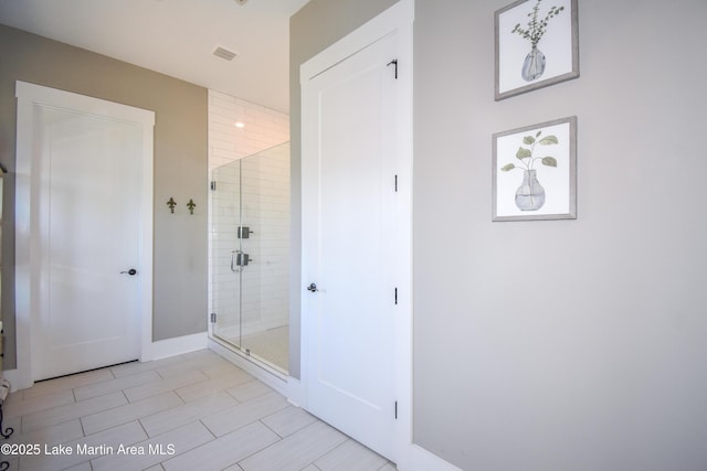 full bath featuring visible vents and a shower stall