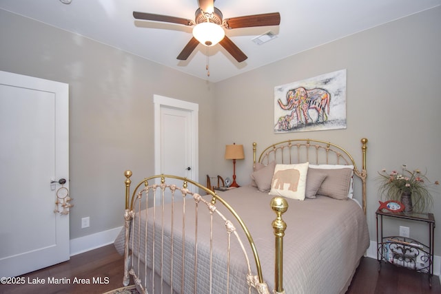 bedroom with baseboards, visible vents, wood finished floors, and ceiling fan