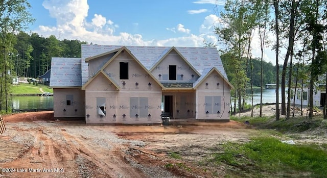 unfinished property featuring a water view and a garage