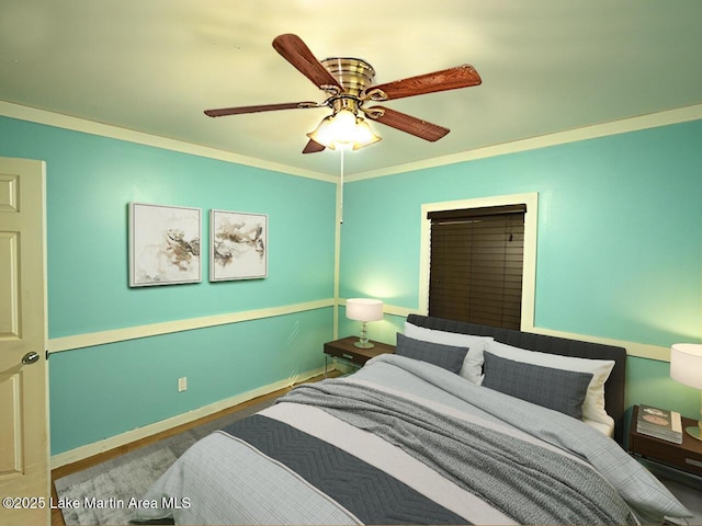 bedroom with crown molding, baseboards, and ceiling fan