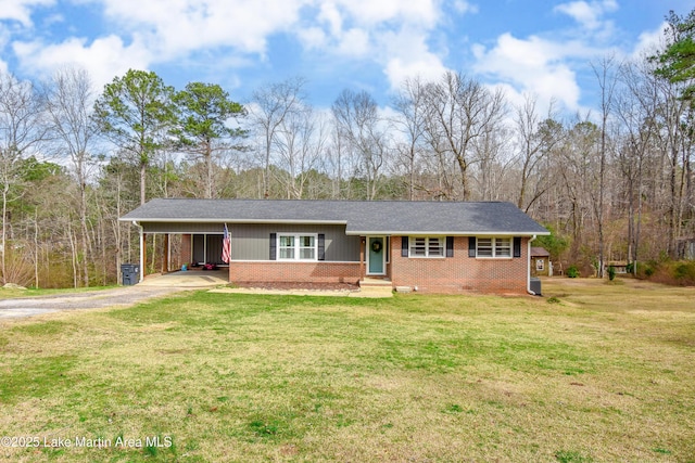 ranch-style home with brick siding, a shingled roof, a carport, driveway, and a front lawn