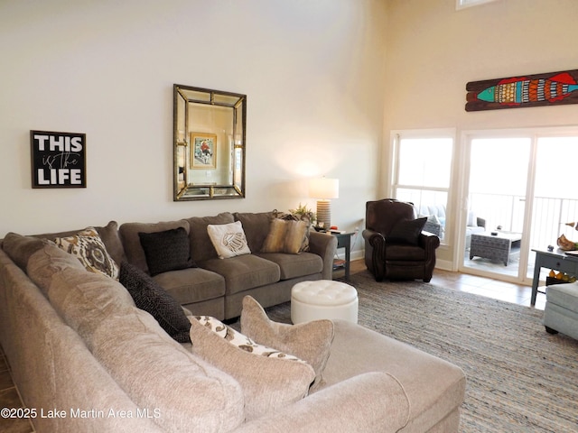 living area with a high ceiling and tile patterned floors