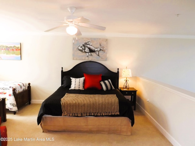 bedroom featuring baseboards, ornamental molding, a ceiling fan, and light colored carpet