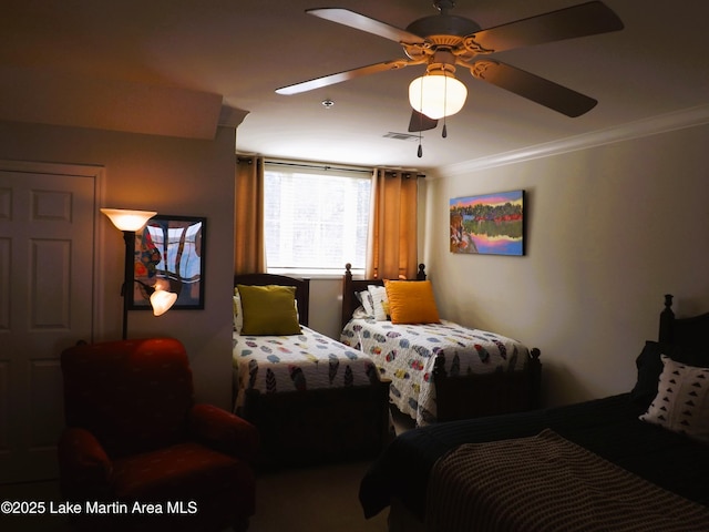 bedroom featuring a ceiling fan, visible vents, and crown molding