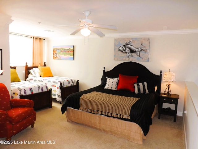 bedroom with a ceiling fan, light colored carpet, and crown molding