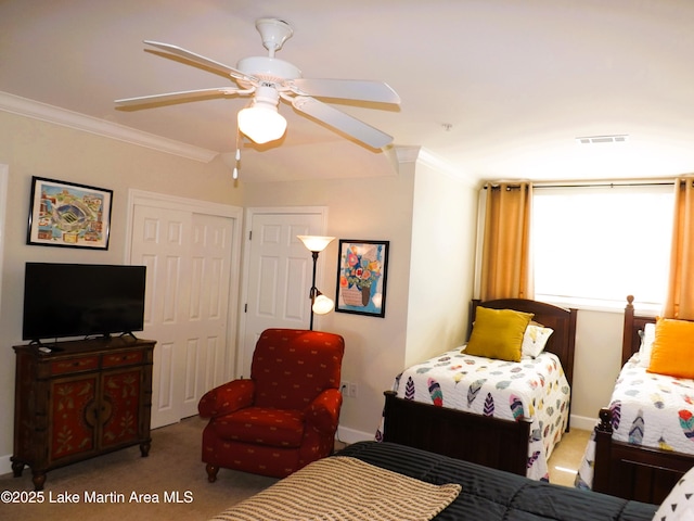 bedroom featuring ceiling fan, light colored carpet, visible vents, ornamental molding, and a closet