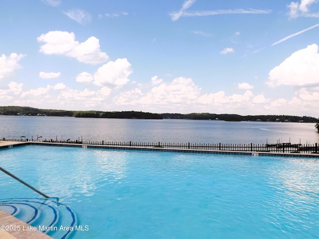 view of swimming pool with a water view