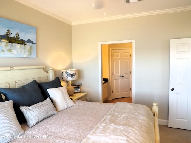 bedroom with carpet, visible vents, crown molding, and baseboards