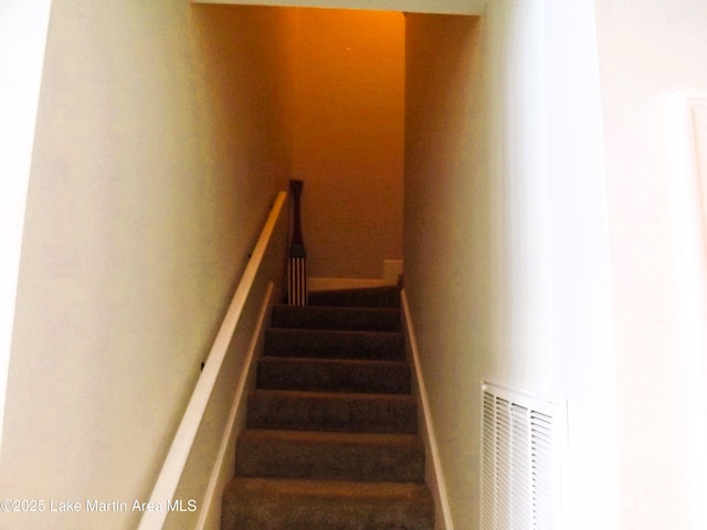 staircase featuring visible vents